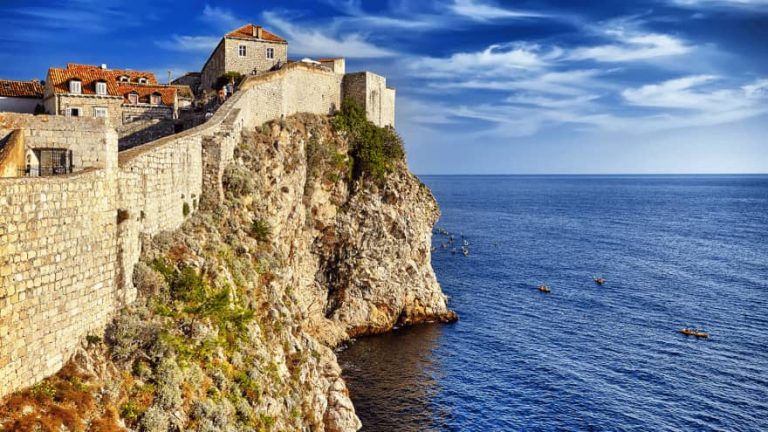 View of the Dubrovnik Old Town Walls from the sea during the clear sunny day.